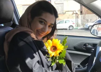 HANDOUT PHOTO: Parnia Abbasi holds a sunflower, her favorite flower, in Tehran, Iran. Abbasi, 23, was killed by an Israeli airstrike at her apartment building in the Sattarkhan neighborhood of Tehran on Friday morning.

(Photo by Arvin Abedi)