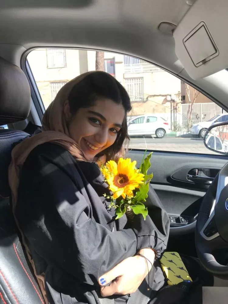 HANDOUT PHOTO: Parnia Abbasi holds a sunflower, her favorite flower, in Tehran, Iran. Abbasi, 23, was killed by an Israeli airstrike at her apartment building in the Sattarkhan neighborhood of Tehran on Friday morning.

(Photo by Arvin Abedi)