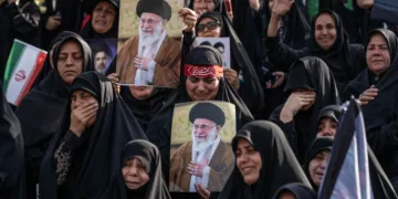 Un grupo de personas sostiene retratos del fallecido líder supremo de Irán, el ayatolá Alí Jamenei, al comienzo de las ceremonias fúnebres.